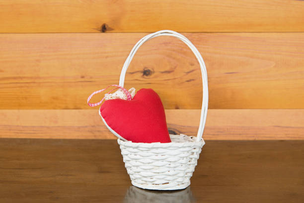 istock Red heart shape in basket on wooden 672968974