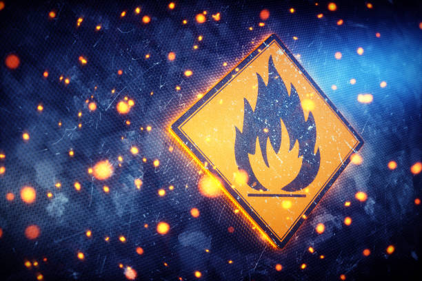 Flammable Sign Closeup With Embers A glowing flame sign representing the international symbol for flammable materials or hazard. The sign is set on a dark blue scratched metallic wall, with glowing embers engulfing it. flammable photos stock pictures, royalty-free photos & images