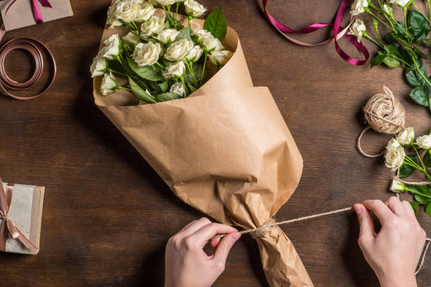 istock hands tying rope on bouquet 672973150