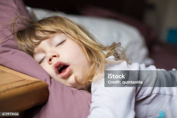 Funny Face Of Child Sleeping On King Bed Stock Photo - Download Image Now - Child, Sleeping, Snoring