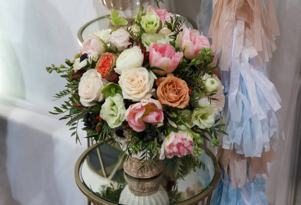 istock Flower bouquet in glass vase on table 672977686