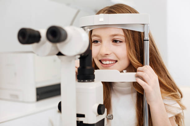 istock Adorable girl getting her eyes checked 672978596