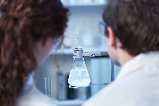 istock Two Scientists Chemist Working Together in a Laboratory in a Chemical Solution 672978856