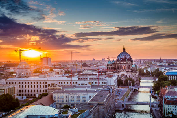 istock Berlin rooftops view with Berlin Cathedral and Spree river at sunset, Germany 672983948