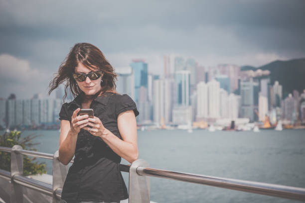 istock Woman using a mobile phone in Hong Kong 673000394