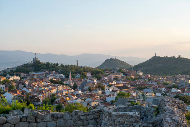 People visit Nebet Tepe hill, part of the ancient city, at sunset in Plovdiv, Bulgaria