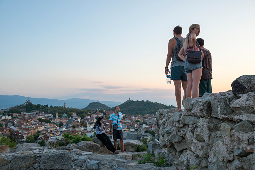 People visit Nebet Tepe hill, part of the ancient city, at sunset in Plovdiv, Bulgaria
