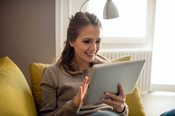 istock Smiling woman Surfing on digital tablet 673000972