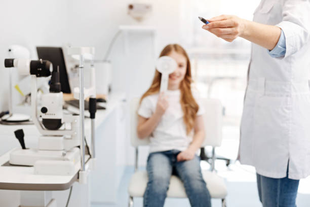 istock Friendly wonderful ophthalmologist checking girls abilities 673001808