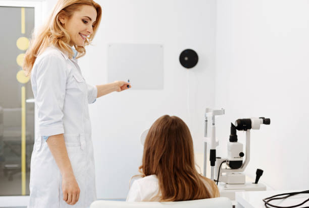istock Lovely friendly ophthalmologist conducting an eyesight test 673006120