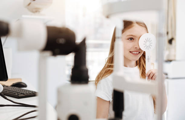 istock Enthusiastic pretty girl performing an eye test 673006372
