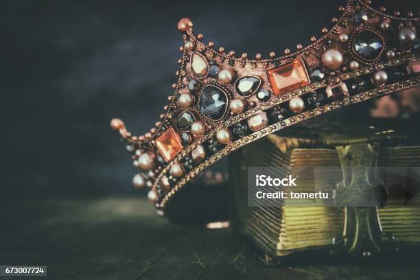 Low Key Image Of Beautiful Queenking Crown On Old Book Stock Photo - Download Image Now