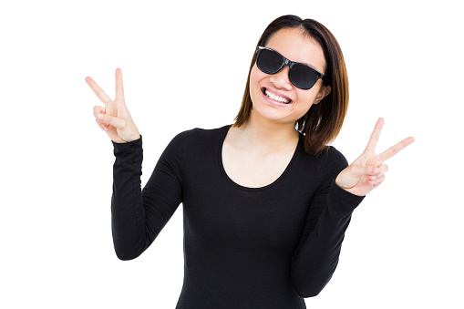 Woman in sunglasses making a v sign on white background