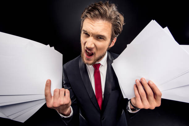 istock Annoyed businessman holding papers 673011030
