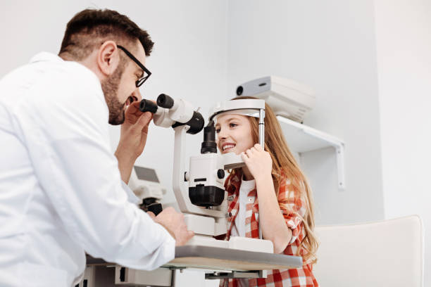 istock Dedicated ophthalmologist applying special equipment for diagnostics 673011612