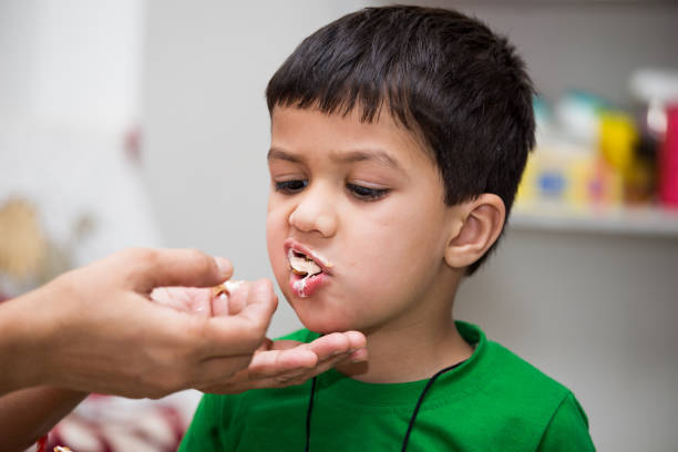 istock Two year old kid eating icecream with joy 673012082