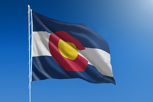 The flag of the state of blowing in the wind in front of a clear blue sky
