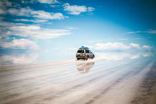 Sports Utility Vehicle driving in the Salar de Uyuni