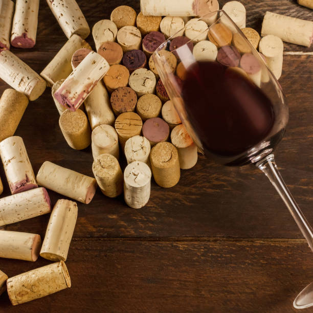 istock Glass of red wine and corks with place for text 673020034