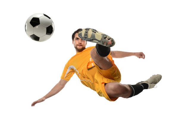 istock Soccer Player Kicking Ball in Midair 673021256