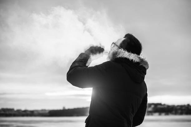 istock Man vape electronic cigarette outdoor 673021644