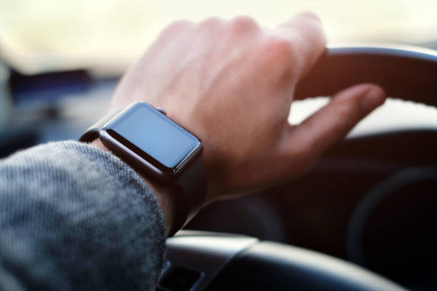 man driving a car with smart watch on the hand stock photo