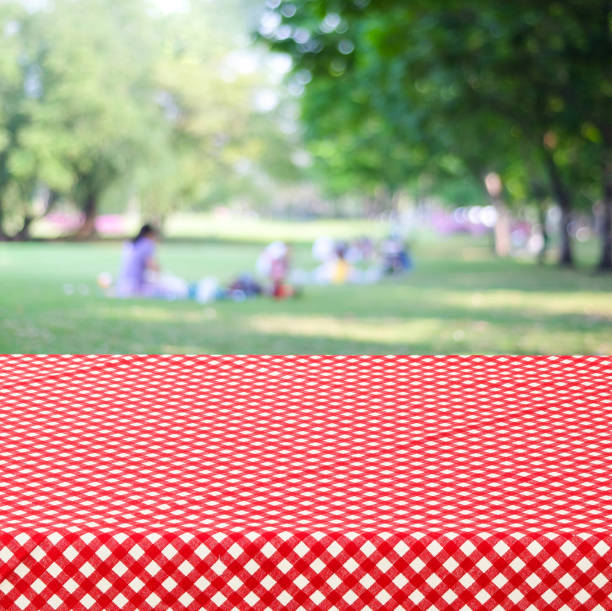 istock Empty table and red tablecloth over blur park with people background, for product display montage 673026296