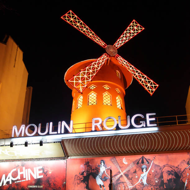 The Moulin Rouge PARIS, FRANCE - MARCH 4: The Moulin Rouge (Red Mill) cbaret at night in Paris, France place pigalle stock pictures, royalty-free photos & images