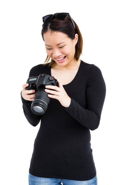 istock Woman looking at picture on digital camera 673033022