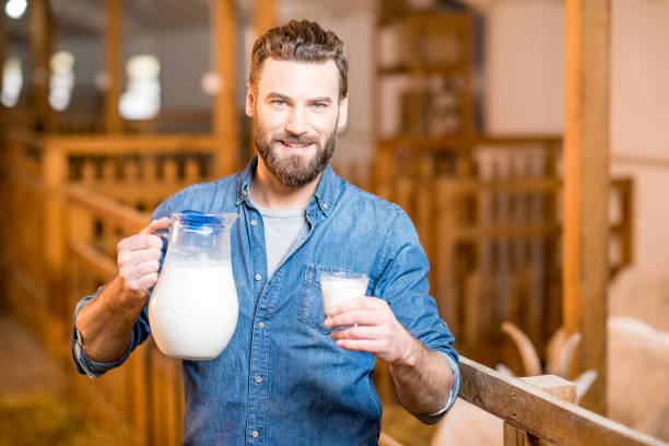 istock Farmer with milk at the goat barn 673033450