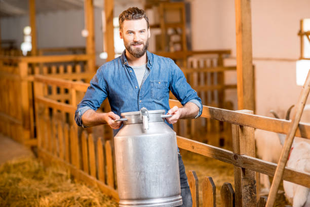 istock Farmer in the goat barn 673033894
