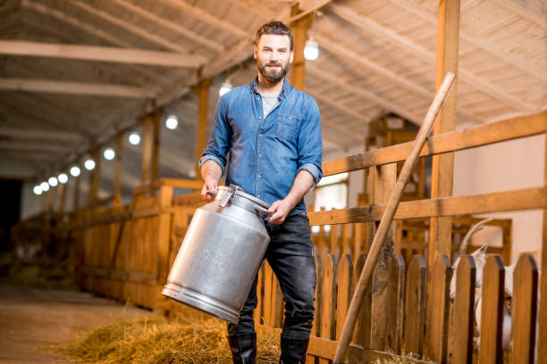 istock Farmer in the goat barn 673034038