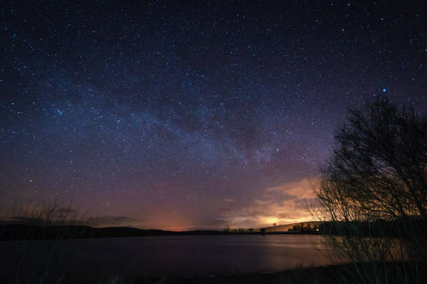 Milky Way above Fontburn Reservoir Fontburn Reservoir in Northumberland is a popular place for fishing and walking, seen her under the stars at night northumberland stock pictures, royalty-free photos & images