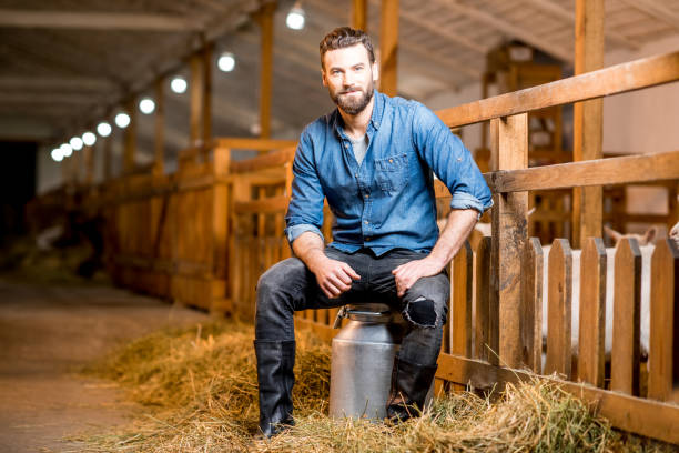 istock Farmer in the goat barn 673034620