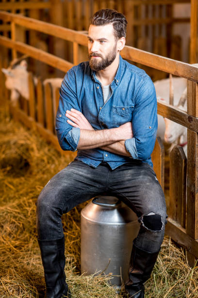 istock Farmer in the goat barn 673034872