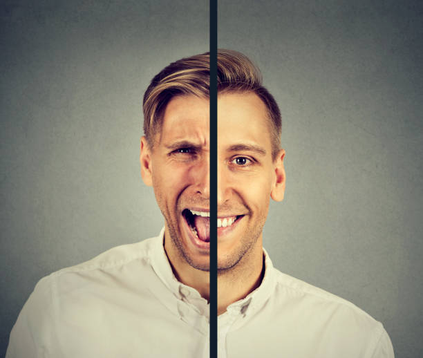 Bipolar disorder concept. Young man with double face expression isolated on gray background