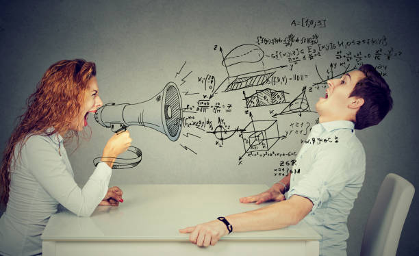 istock angry teacher woman with megaphone shouting at stressed scared student blown away by wave of science math formulas. Negative human emotions 673040262