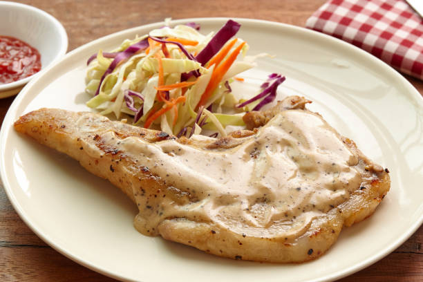 istock Pork chops steak hot grilled with salad, lunch  or dinner dish. 673053226