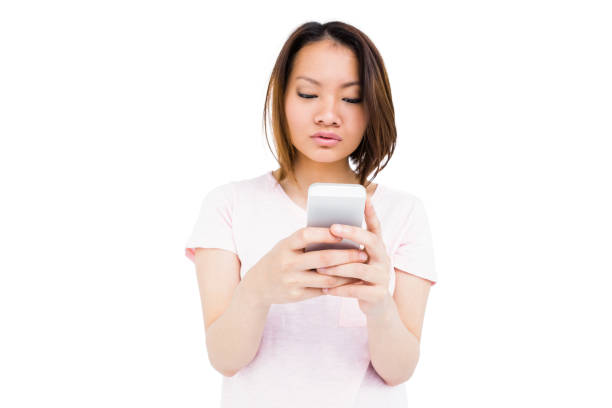 istock Young woman text messaging on mobile phone 673062432