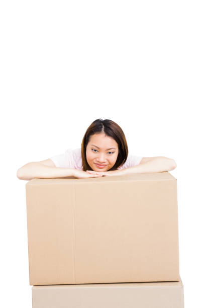 istock Young woman leaning on cardboard box 673063544