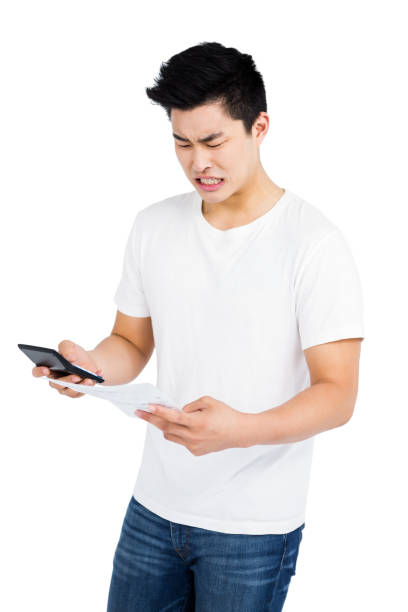 istock Angry man calculating bills on calculator 673064018