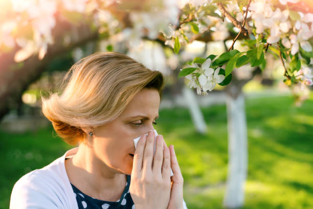 istock Woman sneezing into a tissue 673084372
