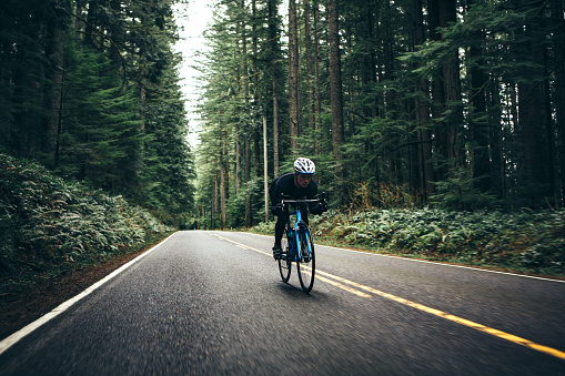 Cyclist Riding Mountain Road on Racing Bike