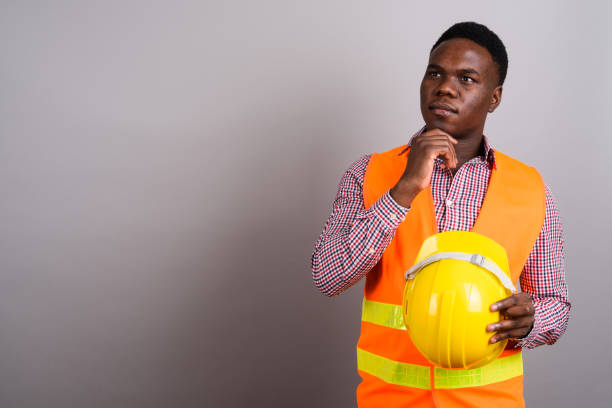 istock Studio shot of young African man construction worker against gray background 673085716
