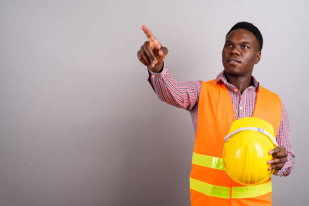 istock Studio shot of young African man construction worker against gray background 673086992