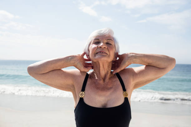 istock Senior woman performing neck exercise 673089890