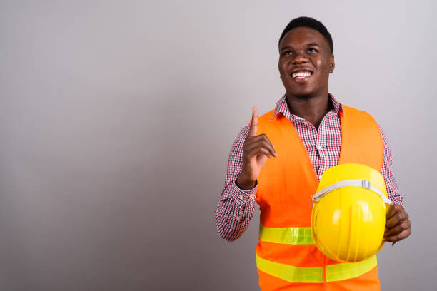 istock Studio shot of young African man construction worker against gray background 673089918