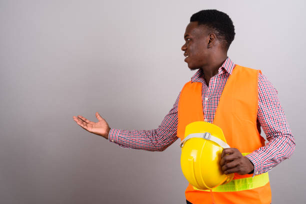 istock Studio shot of young African man construction worker against gray background 673090034