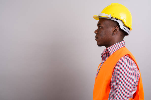 Young construction worker dressing his uniform and protective workwear at a construction site