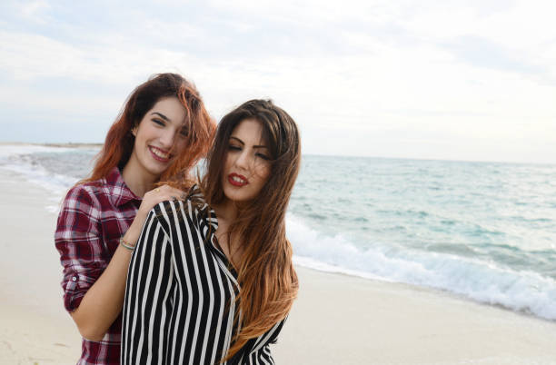 istock gossip girls smiling on the beach 673098332